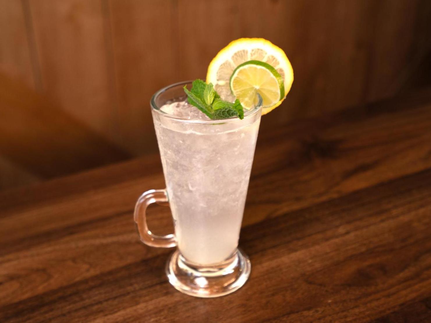 A glass of Lemon Bitter on a wooden table